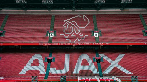 a soccer stadium with a red and green field