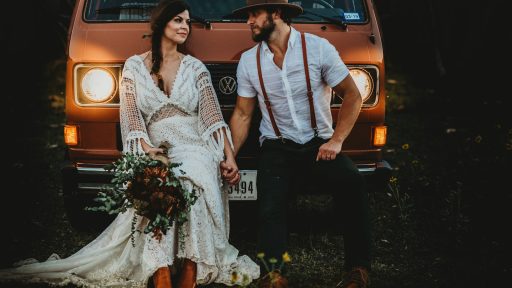 man holding hands of woman while leaning on brown Volkswagen vehicle