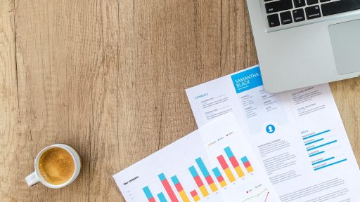 Persoon die financiële grafieken analyseert op een laptop